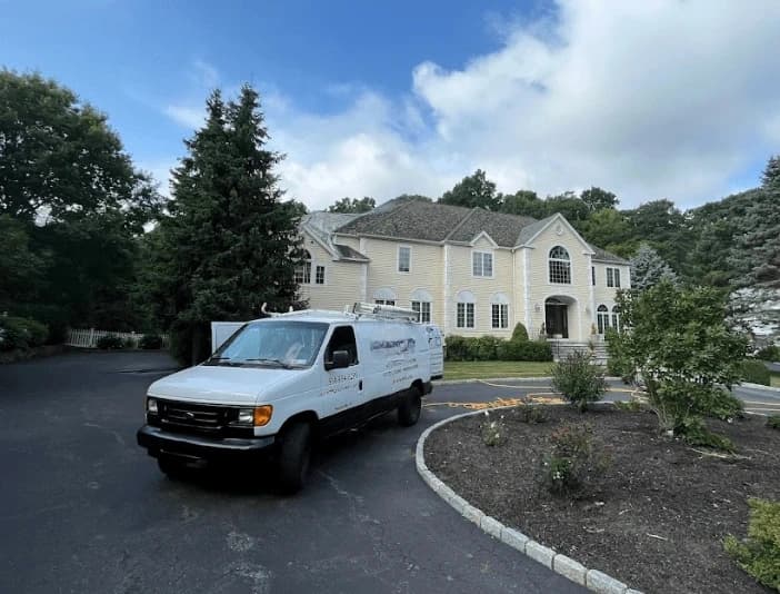 Parma Power Washing technician performing thorough gutter cleaning service in Parma