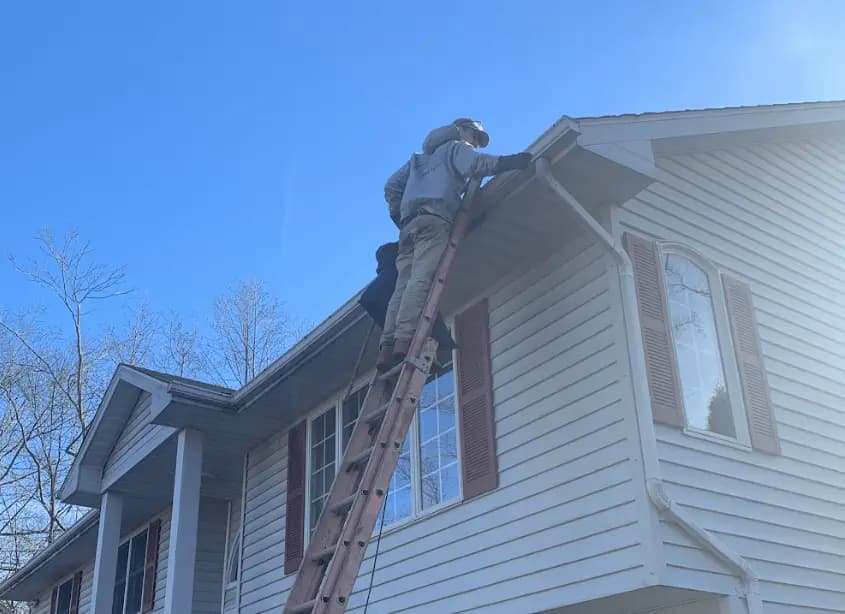 Gutter cleaning and maintenance being performed by Parma Power Washing in Parma